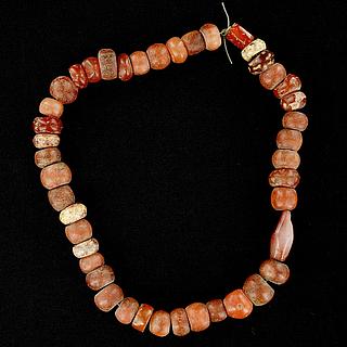 A string of 43 small carnelian beads 05.04.957