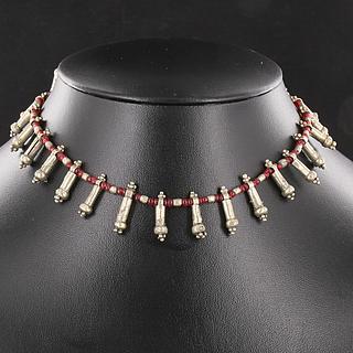 Necklace made with 25 old alloy fertility symbo and red glass beads 02.03.489